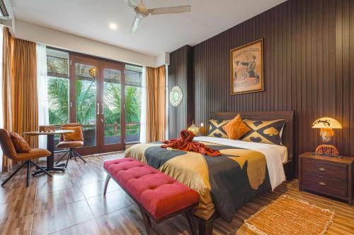 a bedroom with a bed and a table and chairs at The Magic Villa in Lebih
