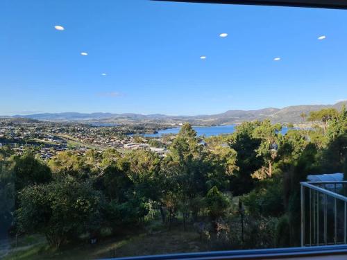 a view from the balcony of a house with a lake at MONA Vista, Tasmania in Rosetta