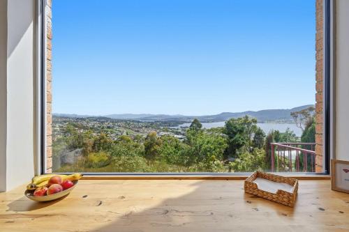 a room with a large window with a bowl of fruit at MONA Vista, Tasmania in Rosetta