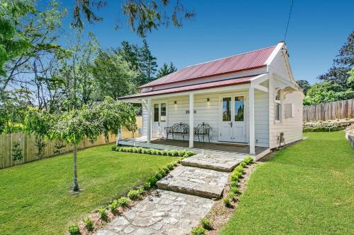a small white house with a red roof at Gowan Brae Cottage - NEW! in Katoomba