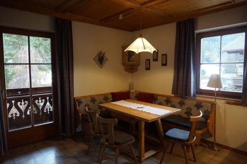 a dining room with a wooden table and chairs at Appartements Huber in Altenmarkt im Pongau