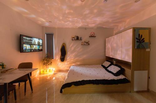 a bedroom with a bed and a dining table at Gấu Studio Ngoại Giao Đoàn in Hanoi