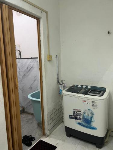 a small bathroom with a stove and a toilet at wawa homestay in Butterworth