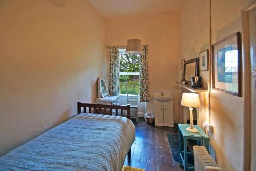 a bedroom with a bed and a table and a window at 4 Bed in Renvyle oc-i258 in Salrock