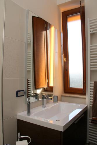 a bathroom with a large white sink and a window at Affittacamere Bellavista in San Marco dei Cavoti