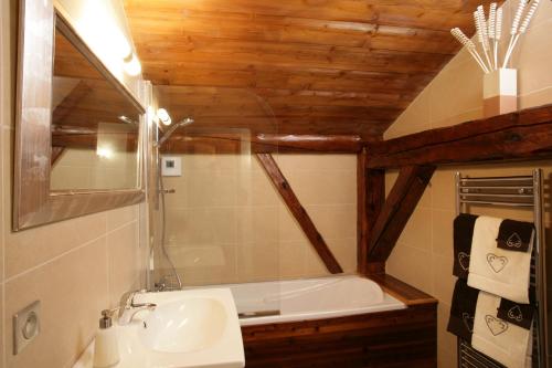 a bathroom with a sink and a bath tub at La Grange De L'Aiguille in Chamonix-Mont-Blanc