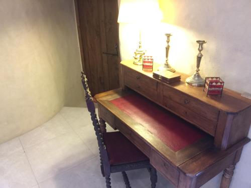 a wooden table with a lamp on top of it at Chateau de la Rode in Aumessas