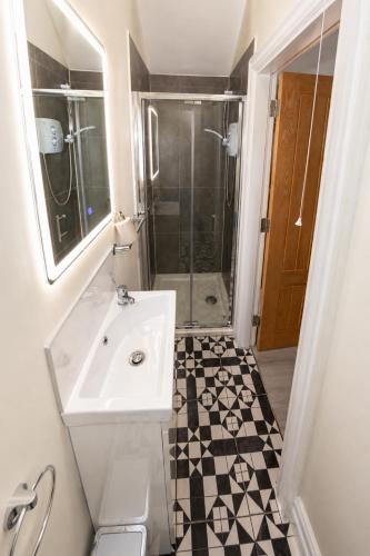 a bathroom with a sink and a shower at Unit 3 Modern Self Contained Apartment in Cobh