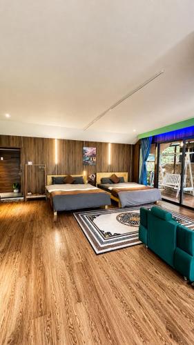 a large room with two beds and a couch at Valley homestay Dalat in Da Thien