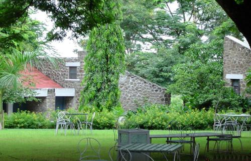 a group of tables and chairs in front of a building at Hotel Kailas in Ellora