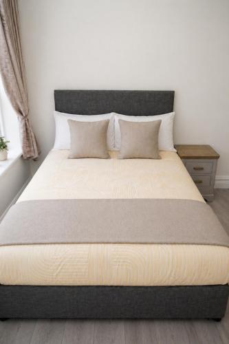 a bed in a bedroom with a large mattress at Unit 1 Island View Apartments - Town Centre Walk To Everything in Cobh