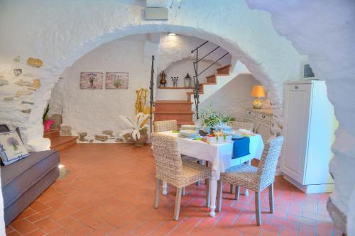 a kitchen with a table and chairs in a room at La Casa di Pietra in Villa Faraldi