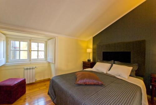 a bedroom with a large bed and a window at Apartments in downtown in Lisbon