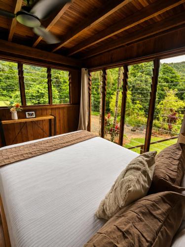a bedroom with a large bed in front of a window at Cape Tribulation Getaway in Cape Tribulation
