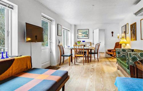 a living room with a table and a dining room at Nice Home In Samsø With Wifi in Ballen