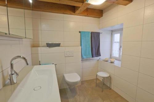 a bathroom with a tub and a toilet and a sink at Ferienhaus Wimbauer in Nennslingen