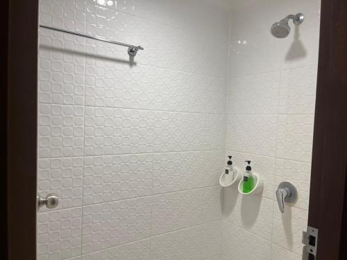 a bathroom with a shower with two bottles on the wall at Basic Simple Family 3 Bedroom for 4 Person in Nathon Bay