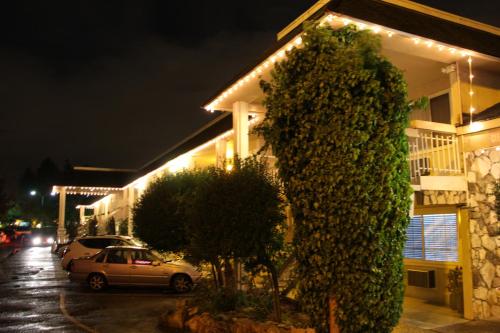 a building with a car parked in a parking lot at night at Caravelle Inn Extended Stay in San Jose