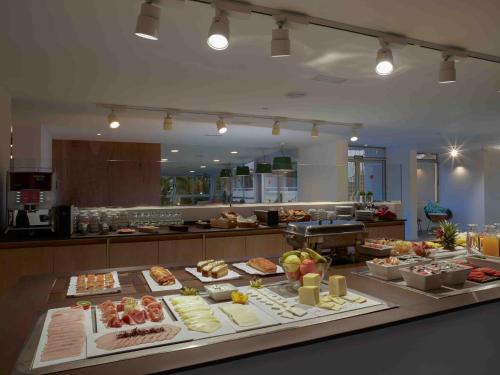 a buffet of food on a table in a kitchen at Route Active Hotel in Los Realejos