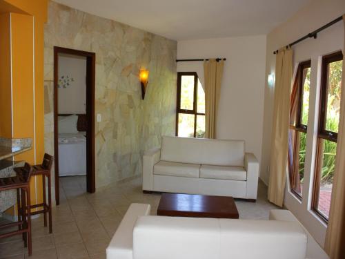 a living room with a couch and a table at Pousada Morada dos Ventos in Pipa