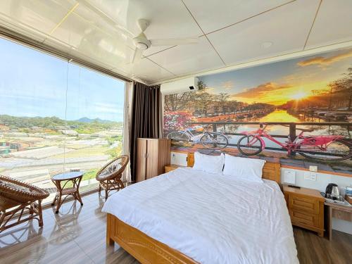 a bedroom with a bed and a large window at Starview Villa Dalat in Da Lat