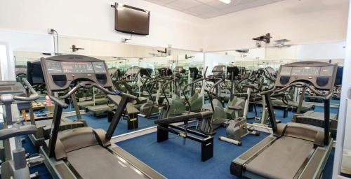 a gym with rows of treadmills and machines at Hotel Weber Ambassador in Capri