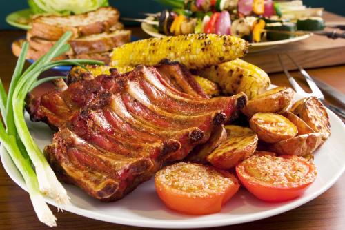 a plate of food with meat and vegetables on a table at Hotel Giessenbach in Fügen