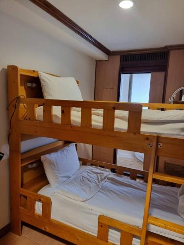 two bunk beds in a room with a window at Basic Simple Family 3 Bedroom for 4 Person in Nathon Bay