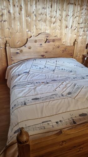 a wooden bed with sheet music on it at Le montagnard in Lullin