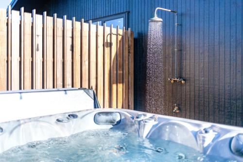 a bath tub in a bathroom with a shower at Toi Toi Apartment in Martinborough