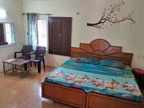 a bedroom with a bed and a table and chairs at Silver holidays in Yercaud