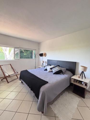 a bedroom with a large bed and a window at Vacation Villa Marina in Puerto Vallarta