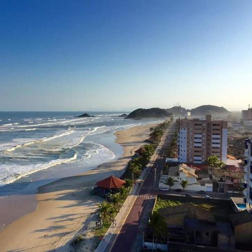 an aerial view of a beach with buildings and the ocean at Hostel Itanhaém in Itanhaém