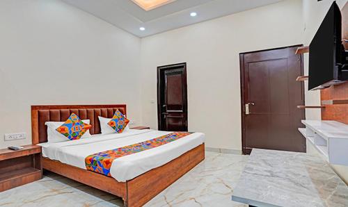 a bedroom with a large bed in a room at Viraj Guest House in Noida