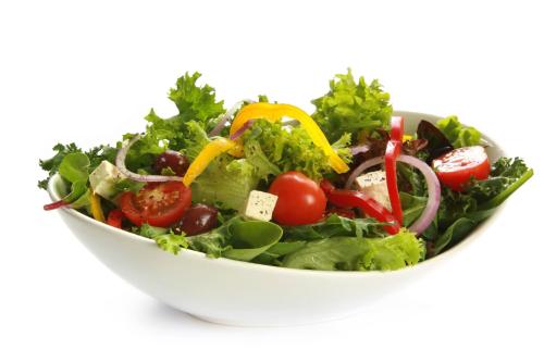 a salad in a white bowl on a white background at Hotel Giessenbach in Fügen