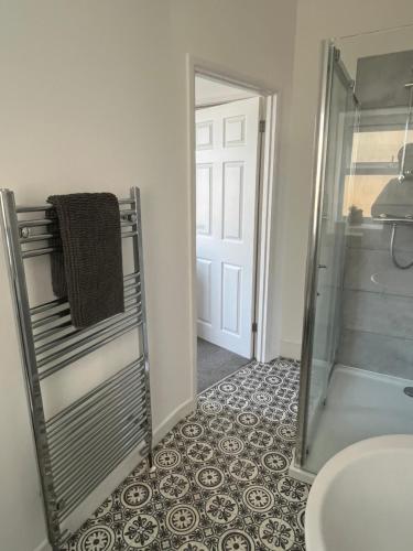 a bathroom with a shower and a glass door at 1 Bed Flat in Weston-super-Mare