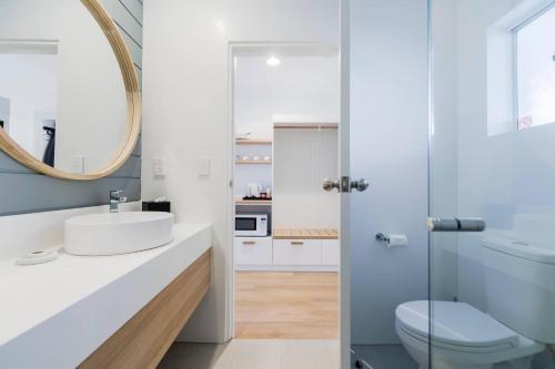 a bathroom with a sink and a mirror at The Quarters, an Ascend Collection Hotel in Wamberal