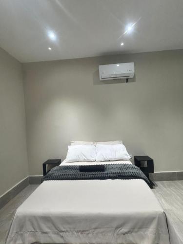 a bedroom with a large bed with a air conditioner at Casa KM222 in Esquipulas