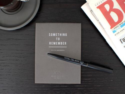 a pen sitting on a table next to a paper at Vital - Urban boutique hotel TLV in Tel Aviv