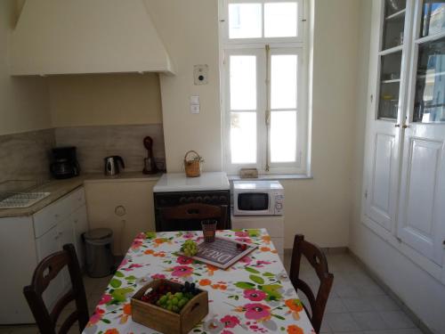 a kitchen with a table with a bowl of fruit on it at Neoclassical House in Chania