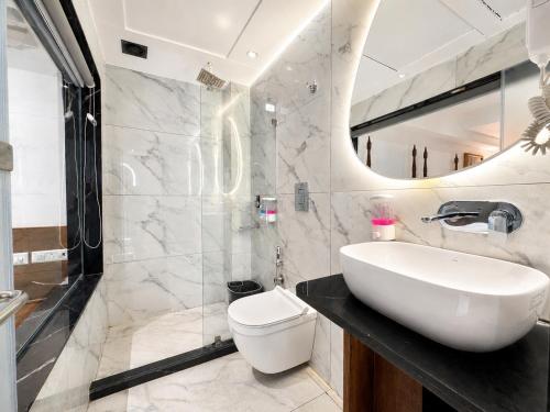 a bathroom with a sink and a toilet at Hotel Hari Piorko - New Delhi Railway Station in New Delhi