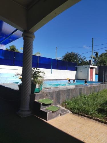 two people are swimming in a swimming pool at Blue Horizon Villa in Grand Baie in Grand-Baie