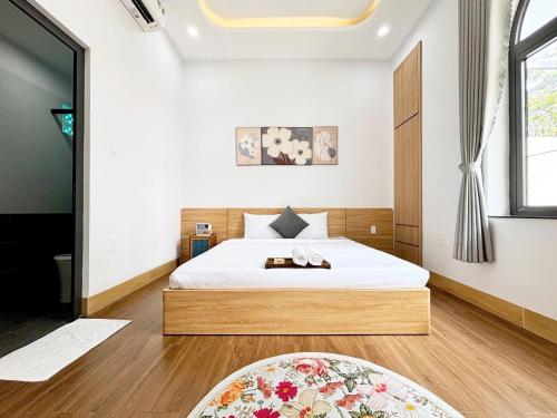 a bedroom with a bed and a large window at ECHO VILLA PHAN THiET in Phan Thiet