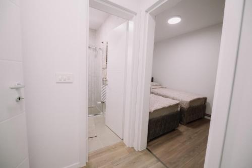 a bathroom with a bed and a walk in shower at KDolićiM in Livno