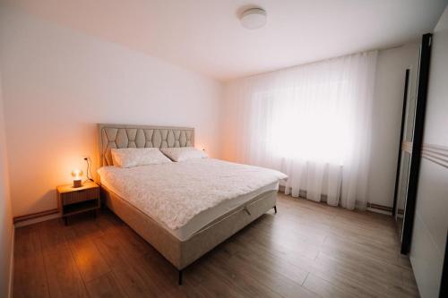 a bedroom with a large bed and a window at KDolićiM in Livno