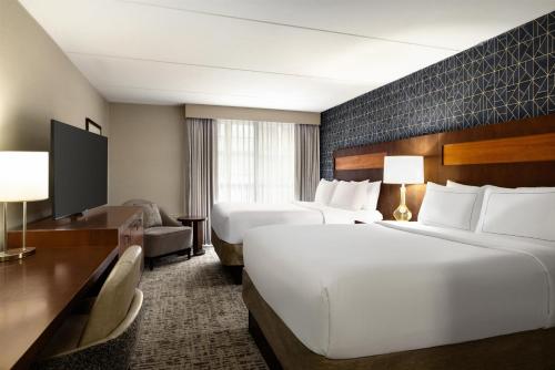 a hotel room with two beds and a desk at DoubleTree by Hilton Pittsburgh-Green Tree in Pittsburgh