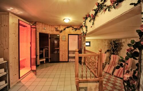a room with a staircase with flowers on the walls at Gletscher-Landhaus Brunnenkogel in Sankt Leonhard im Pitztal