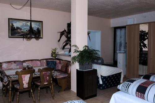 uma sala de estar com um sofá e uma mesa em Caruso Pension und Pizzeria em Salzweg