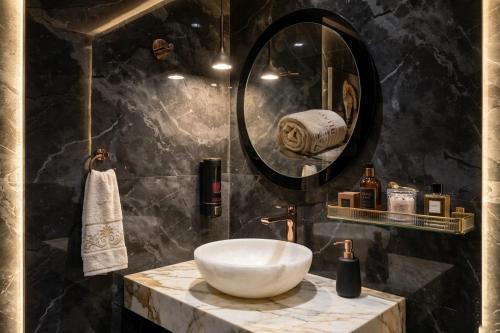 a bathroom with a sink and a mirror at Hotel Banaras Vandanam in Varanasi