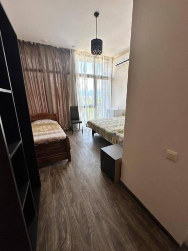 a hotel room with two beds and a window at TheStarryNight in P'ichvnari